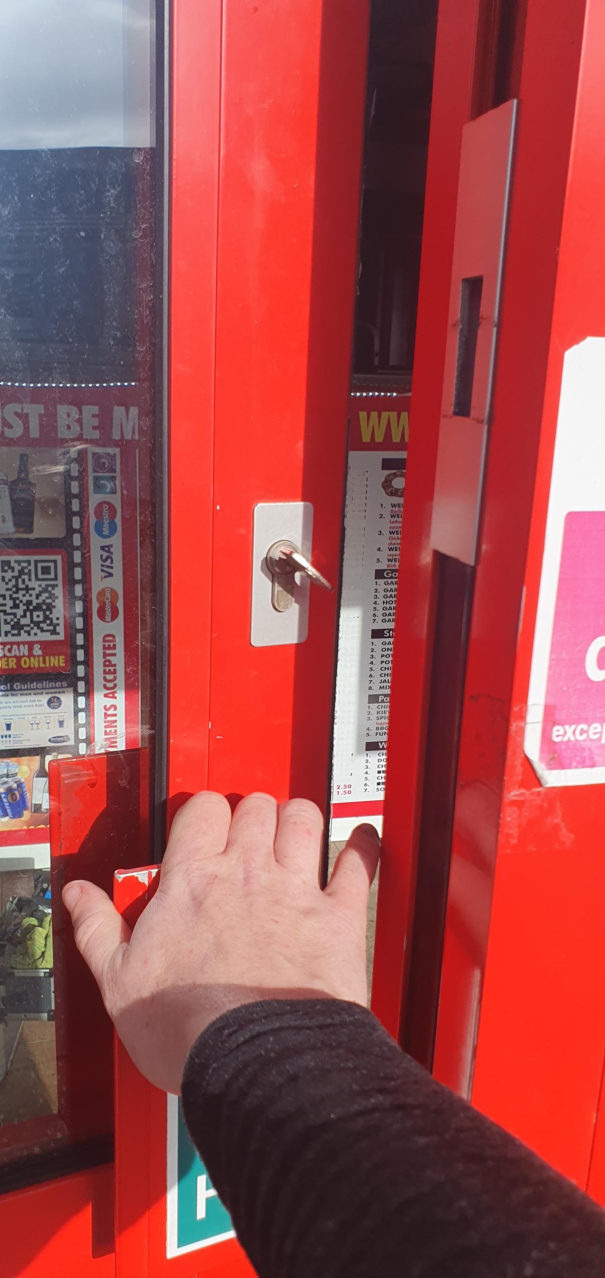 AD Locksmithing holding a broken part of a lock that has been fixed.