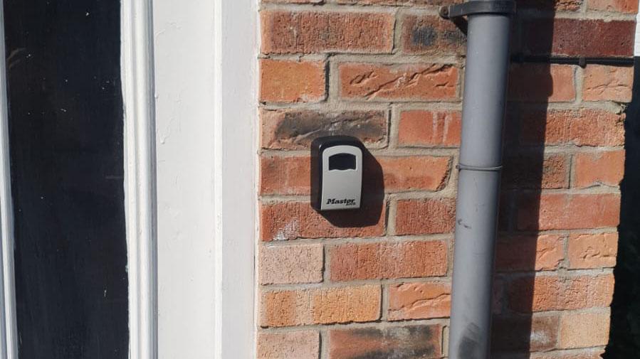 A photo of a keysafe installed on a outside wall by a locksmith