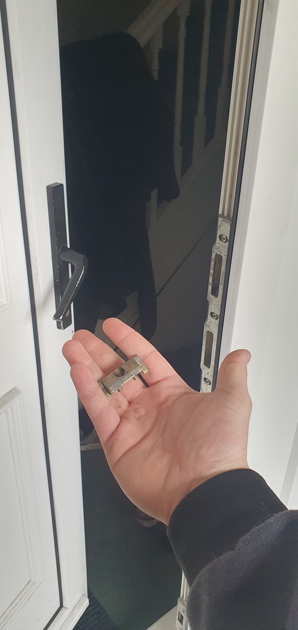Emergency Locksmith Solutions AD Locksmithing holding part of a broken door lock