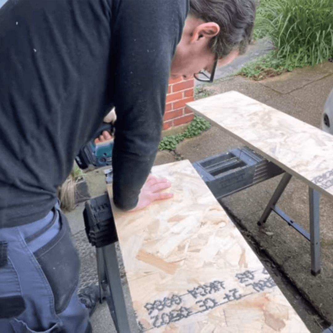 Emergency Locksmith Solutions Ant from AD Locksmith cutting a board to board up a window